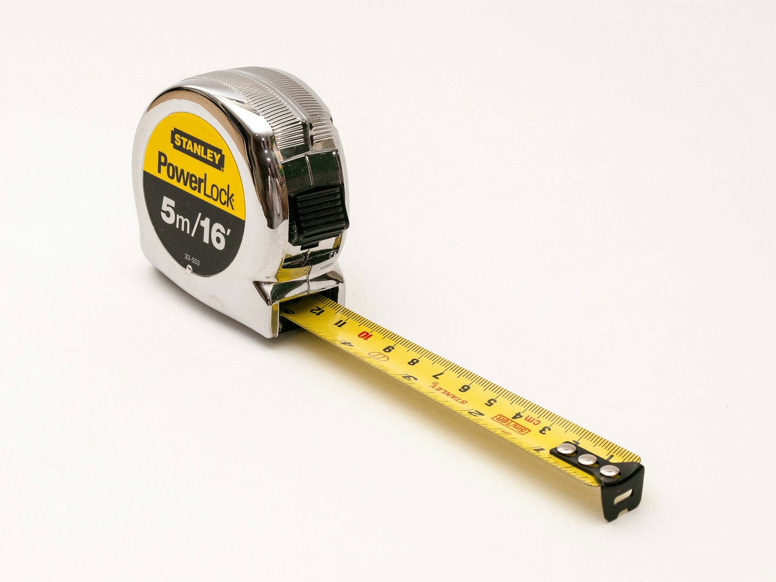A yellow tape measure extends across a light background.